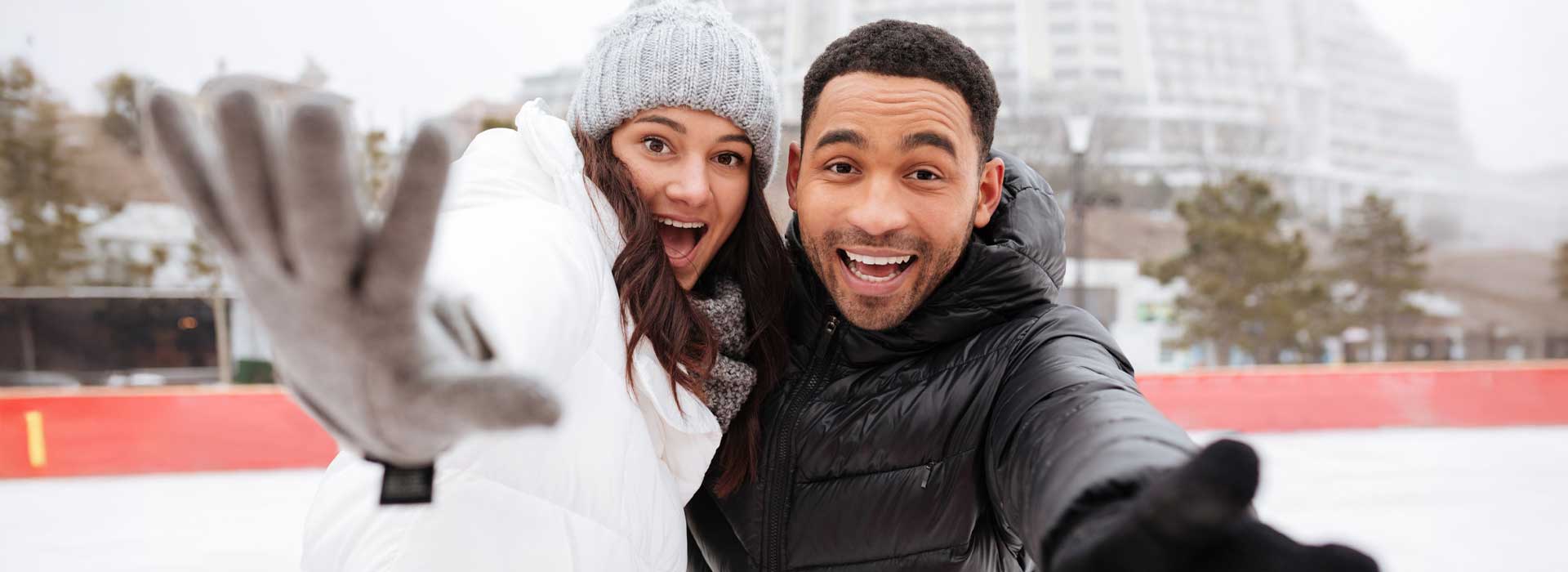 A happy couple taking a selfie in the snow